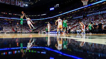 Jayson Tatum #0 of the Boston Celtics shoots over Caleb Martin #16