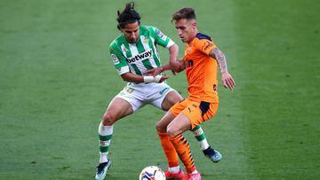 SEVILLE, SPAIN - APRIL 18: Diego Lainez of Real Betis and Alex Blanco of Valencia CF  battle for the ball  during the La Liga Santander match between Real Betis and Valencia CF at Estadio Benito Villamarin on April 18, 2021 in Seville, Spain. Sporting sta