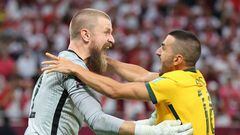 Australia's goalkeeper Andrew Redmayne (L) celebrates with Australia's defender Aziz Behich after winning the FIFA World Cup 2022 inter-confederation play-offs match between Australia and Peru on June 13, 2022, at the Ahmed bin Ali Stadium in the Qatari city of Ar-Rayyan. (Photo by KARIM JAAFAR / AFP) (Photo by KARIM JAAFAR/AFP via Getty Images)
