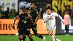 Oct 20, 2022; Los Angeles, California, US; Los Angeles FC defender Diego Palacios (12) and Los Angeles Galaxy midfielder Riqui Puig Marti (6) battle during the second half of the MLS Cup Playoff semifinal at Banc Of California Stadium. Mandatory Credit: Gary A. Vasquez-USA TODAY Sports