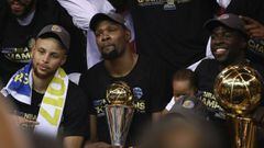 OAKLAND, CA - JUNE 12: Stephen Curry #30, Kevin Durant #35 with the Bill Russell NBA Finals Most Valuable Player Award and Draymond Green #23 (holding the Larry O&#039;Brien Championship Trophy) of the Golden State Warriors celebrate after defeating the Cleveland Cavaliers 129-120 in Game 5 to win the 2017 NBA Finals at ORACLE Arena on June 12, 2017 in Oakland, California. NOTE TO USER: User expressly acknowledges and agrees that, by downloading and or using this photograph, User is consenting to the terms and conditions of the Getty Images License Agreement.   Ezra Shaw/Getty Images/AFP == FOR NEWSPAPERS, INTERNET, TELCOS &amp; TELEVISION USE ONLY ==