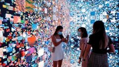 Visitors are pictured in front of an immersive art installation titled &quot;Machine Hallucinations &mdash; Space: Metaverse&quot; by media artist Refik Anadol, which will be converted into NFT and auctioned online at Sotheby&#039;s, at the Digital Art Fair, in Hong Kong, China September 30, 2021.