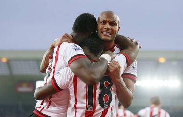 Lamine Kone celebrates scoring the third goal for Sunderland with Younes Kaboul and Jermain Defoe