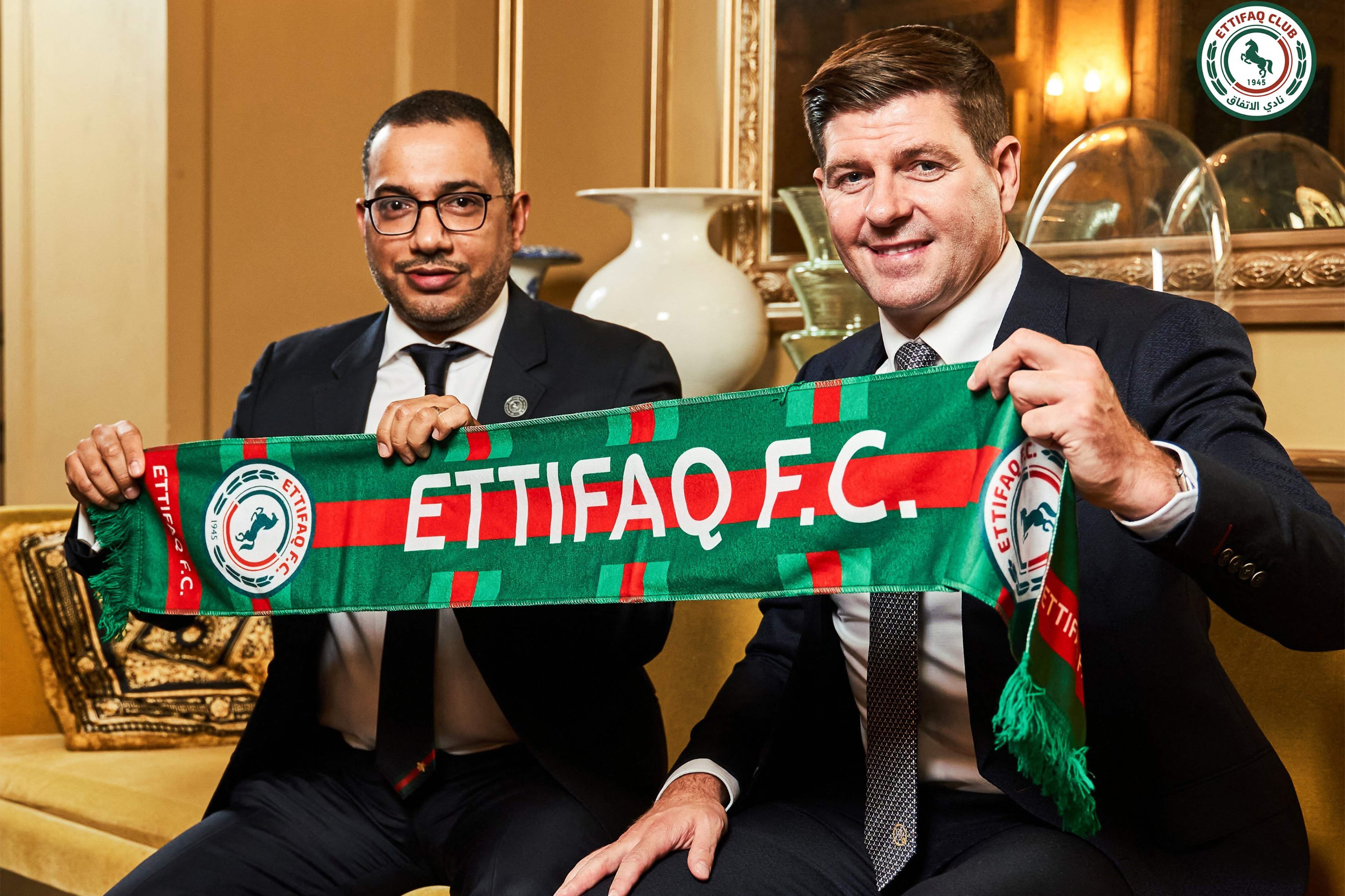 This handout picture released by Saudi Arabia's al-Ettifaq football club on July 3, 2023 shows Ettifaq's new English manager Steven Gerrard (R) with the club's President Khaled al-Debel after signing with them in London. (Photo by Al Ettifaq Football Club / AFP) / == RESTRICTED TO EDITORIAL USE - MANDATORY CREDIT "AFP PHOTO / HO /AL ETTIFAQ FOOTBALL CLUB" - NO MARKETING NO ADVERTISING CAMPAIGNS - DISTRIBUTED AS A SERVICE TO CLIENTS ==