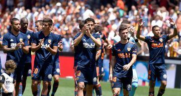 Valencia players celebrate their win at the end of the Spanish league football match between Valencia CF and RC Deportivo de la Coruna at the Mestalla stadium in Valencia on May 20, 2018.