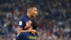 France's forward #10 Kylian Mbappe celebrates with France's defender #22 Theo Hernandez after scoring his team's first goal during the Qatar 2022 World Cup Group D football match between France and Denmark at Stadium 974 in Doha on November 26, 2022. (Photo by FRANCK FIFE / AFP)