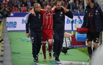 Bayern Munich's French midfielder Franck Ribery is helped off the pitch by medical staff.