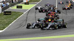 Nico Rosberg and Lewis Hamilton battle for position into the first corner 
