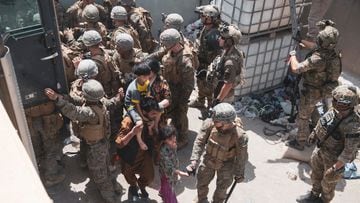US Marines and Norwegian coalition forces assist with security at an Evacuation Control Checkpoint ensuring evacuees are processed safely during an evacuation at Hamid Karzai International Airport, Kabul.