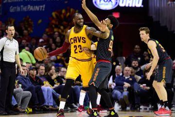 LeBron James of the Cleveland Cavaliers looks for a pass while under pressure from DeAndre' Bembry