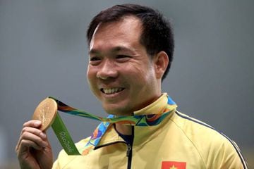 Vietnam's gold medallist Hoang Xuan Vinh poses on the podium during the medal ceremony for the men's 10m Air Pistol shooting event.