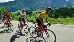 Australia&#039;s Richie Porte (R), wearing the overall leader&#039;s yellow jersey, and his teammate Ireland&#039;s Nicolas Roche (C) ride in the pack during the 168 km seventh stage of the 69th edition of the Criterium du Dauphine cycling race on June 10