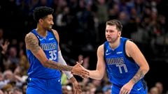 Dallas Mavericks center Christian Wood (35) and guard Luka Doncic (77) celebrate during the second half against the Denver Nuggets at the American Airlines Center.