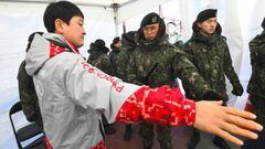 South Korean soldiers inspect a visitor at a security checkpoint as they replace security guards showing symptoms of the norovirus at the Gangneung Ice Arena in Gangneung on February 6, 2018 ahead of the Pyeongchang 2018 Winter Olympic Games.
 According t