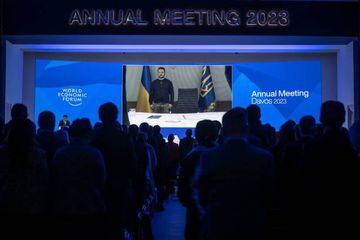 Ukrainian President Volodymyr Zelensky stand for a minute of silence to pay tribute to Ukraine's late interior minister at the Congress centre during the WEF annual meeting in Davos on January 18, 2023. 