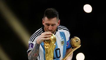 FILE PHOTO: Soccer Football - FIFA World Cup Qatar 2022 - Final - Argentina v France - Lusail Stadium, Lusail, Qatar - December 18, 2022 Argentina's Lionel Messi kisses the World Cup trophy after receiving the Golden Ball award as he celebrates after winning the World Cup REUTERS/Kai Pfaffenbach/File Photo