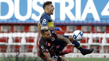 Tijuana&#039;s Julian Velazquez, below, collides with Boca Juniors&#039;s Carlos Tevez during the first half of a friendly soccer match Wednesday, July 10, 2019, in Tijuana, Mexico. (AP Photo/Gregory Bull)
