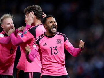 Scotland's Ikechi Anya celebrates after his side's 89th minute goal against Slovakia that keeps them in with a chance of qualifying for Russia 2018. Scotland's away kit for the qualifying campaign has been this bright pink number that's been a huge hit wi