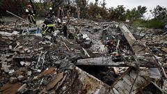 Firefighters and Ukrainian army soldiers search for bodies of people killed during a Russian attack, among the remains of a building beside a TV tower, in the recently liberated town of Izium, Kharkiv region, Ukraine September 28, 2022.  REUTERS/ Zohra Bensemra