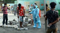 Guwahati (India), 01/07/2020.- A worker sprays disinfectant on a worker, engaged in construction of a COVID-19 care center, in Guwahati, India, 01 July 2020. Countries around the world are taking measures to stem the spread of the SARS-CoV-2 coronavirus, 