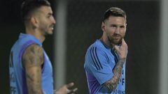 Argentina's forward Lionel Messi (R) gestures next to Argentina's forward Angel Correa during a training session at Qatar University in Doha, on December 5, 2022 ahead of the Qatar 2022 World Cup quarterfinal football match against Netherlands. (Photo by JUAN MABROMATA / AFP) (Photo by JUAN MABROMATA/AFP via Getty Images)