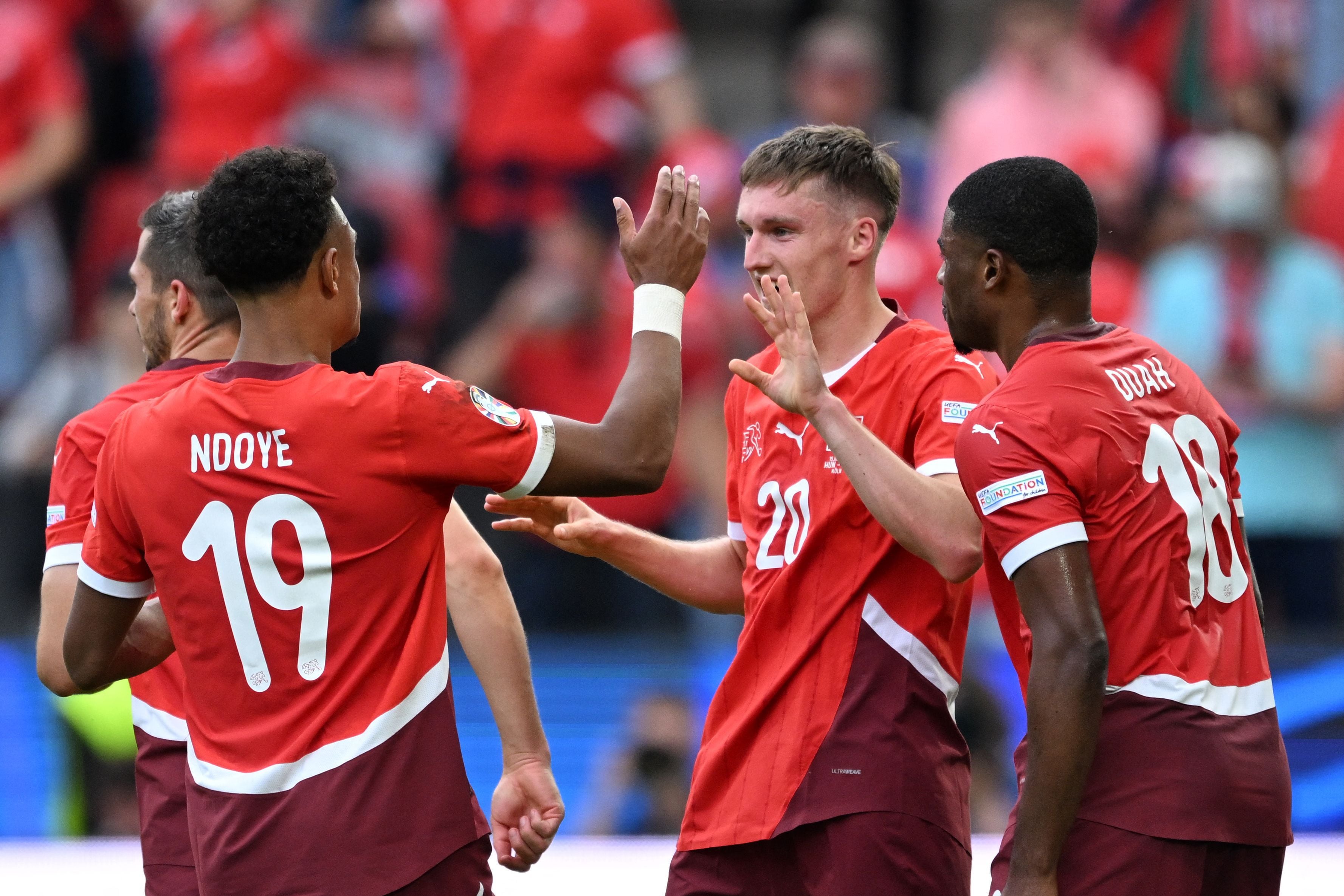 Switzerland's midfielder #20 Michel Aebischer celebrates scoring his team's second goal with his teammates during the UEFA Euro 2024 Group A football match between Hungary and Switzerland at the Cologne Stadium in Cologne on June 15, 2024. (Photo by Kirill KUDRYAVTSEV / AFP)