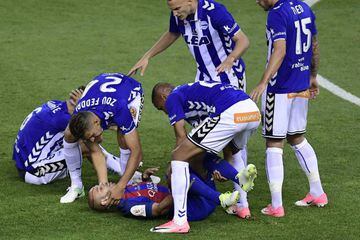 Barcelona's Argentinian defender Javier Mascherano is helped by Deportivo Alaves players.