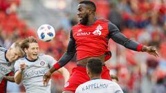 FILE - In this July 28, 2018, file photo, Toronto FC&#039;s Jozy Altidore leaps for the ball between Chicago Fire players, including Johan Kappelhof (4), during the first half of an MLS soccer match, in Toronto. Toronto FC confirmed Thursday, Feb. 28, 2019, that star striker Jozy Altidore is staying put. The 29-year-old U.S. international has signed a three-year contract extension that will keep him in Toronto through the 2022 season.(Mark Blinch/The Canadian Press via AP, File)