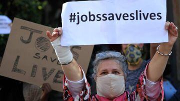 A restaurant worker holds a placard during a protest against the coronavirus disease (COVID-19) restrictions in Cape Town, South Africa, July 22, 2020. REUTERS/Mike Hutchings