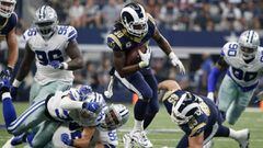 Los Angeles Rams running back Todd Gurley (30) breaks tackle attempt by Dallas Cowboys safety Jeff Heath (38) and defensive tackle Brian Price (92) on a carry late in the second half of an NFL football game, Sunday, Oct. 1, 2017, in Arlington, Texas. (AP Photo/Michael Ainsworth)