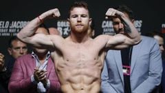 Canelo Alvarez poses on the scale during a weigh-in for his middleweight title boxing match against Daniel Jacobs, Friday, May 3, 2019, in Las Vegas. The two are scheduled to fight Saturday in Las Vegas. (AP Photo/John Locher)