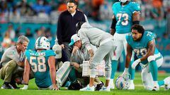 MIAMI GARDENS, FLORIDA - DECEMBER 11: Miami Dolphins coaching and training staff tend to Connor Williams #58 of the Miami Dolphins in the first quarter at Hard Rock Stadium on December 11, 2023 in Miami Gardens, Florida.   Rich Storry/Getty Images/AFP (Photo by Rich Storry / GETTY IMAGES NORTH AMERICA / Getty Images via AFP)