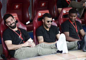 Arda Turan, Rafinha and Marlon in the visitors' dug-out at the Vicente Calderón.
