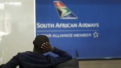 FILE PHOTO: A passenger is seen at the South African Airways customer desk after SAA announced an immediate suspension of all intercontinental flights in response to a travel ban aimed at curbing the coronavirus outbreak, at O.R. Tambo International Airpo