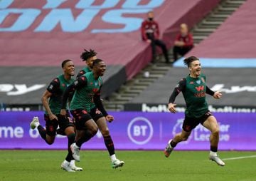 Aston Villa's English midfielder Jack Grealish (R) runs to celebrate scoring the opening goal during the English Premier League football match between West Ham United and Aston Villa at The London Stadium, in east London on July 26, 2020.
