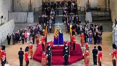 Members of the public file past the coffin of Queen Elizabeth II, draped in the Royal Standard with the Imperial State Crown and the Sovereign's orb and sceptre, lying in state.