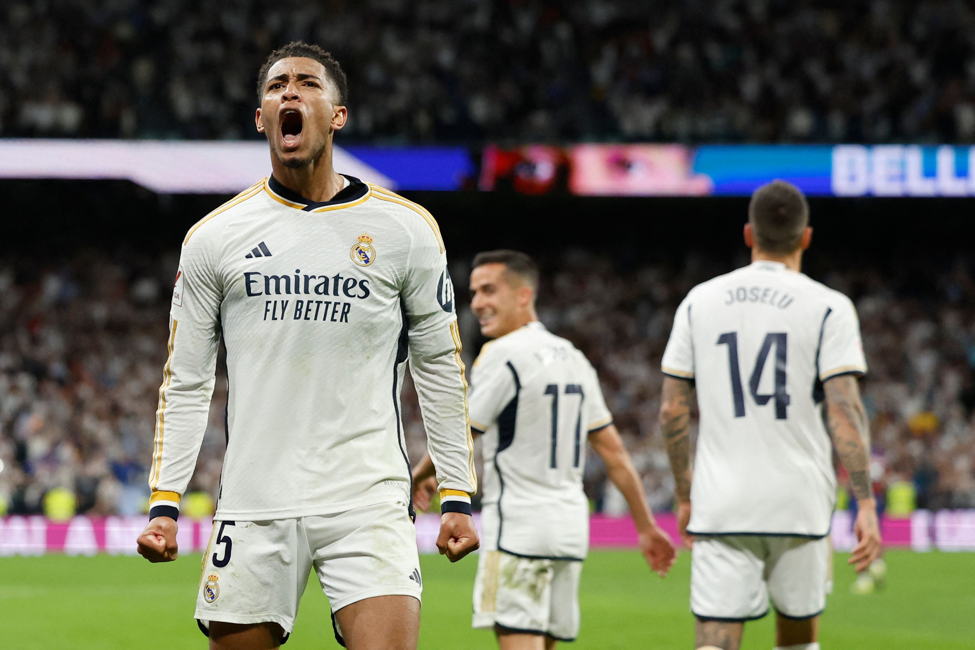Real Madrid's English midfielder #5 Jude Bellingham celebrates scoring his team's third goal during the Spanish league football match between Real Madrid CF and FC Barcelona at the Santiago Bernabeu stadium in Madrid on April 21, 2024. (Photo by OSCAR DEL POZO / AFP)