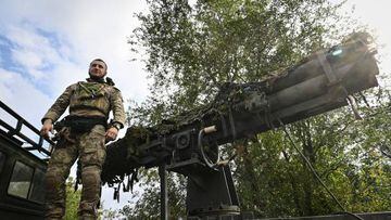 Ukrainian soldier with call-sign Ryba, which means "fish" in English, stands on the vehicle with a homemade four-tube multiple rocket launcher n Kryvyi Rih on September 28, 2022,  amid the Russian invasion of Ukraine. (Photo by Genya SAVILOV / AFP) (Photo by GENYA SAVILOV/AFP via Getty Images)