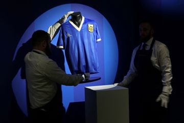 Sotheby's technicians adjust the shirt worn by Argentina's Diego Maradona during the 1986 World Cup quarter-final match against England. The jersey that Argentina football legend Diego Maradona wore when scoring twice against England in the 1986 World Cup, including the infamous "hand of God" goal, was auctioned for $9.3 million, a record for any item of sports memorabilia, Sotheby's said in May. 