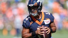 Quarterback Russell Wilson of the Denver Broncos practices with his team during training camp at UCHealth Training Center on July 27, 2022 in Englewood, Colorado.