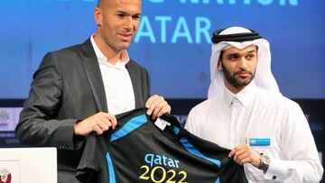 Hassan Al-Thawadi (R) presents the new official ambassador Zinedine Zidane, former France International and World cup winner with a personalised shirt during a press conference at the Four Seasons hotel in Doha, Qatar, 16 September 2010