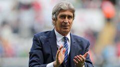 Manchester City&#039;s Chilean manager Manuel Pellegrini applauds on the pitch after the English Premier League football match between Swansea City and Manchester City at The Liberty Stadium in Swansea, south Wales on May 15, 2016. The game finished 1-1.