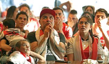 Fans of Argentina's River Plate team react after their team lost 2-1 the Copa Libertadores football final against Brazil's Flamengo at a bar in Buenos Aires, on November 23, 2019. 