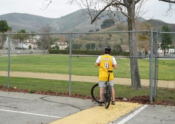 A Lakers fan watches the column of smoke coming from the accident site.
