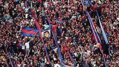 Fans of San Lorenzo cheer for their team during their Argentine Professional Football League Tournament 2022 match against Boca Juniors at Nuevo Gasometro stadium in Buenos Aires, on July 9, 2022. (Photo by ALEJANDRO PAGNI / AFP) (Photo by ALEJANDRO PAGNI/AFP via Getty Images)