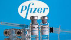 FILE PHOTO: Vials labelled &quot;COVID-19 Coronavirus Vaccine&quot; and a syringe are seen in front of the Pfizer logo in this illustration taken February 9, 2021. REUTERS/Dado Ruvic/Illustration/File Photo