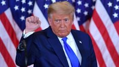 (FILES) In this file photo US President Donald Trump pumps his fist after speaking during election night in the East Room of the White House in Washington, DC, early on November 4, 2020. - US President Donald Trump hailed the &quot;great news&quot; on Nov