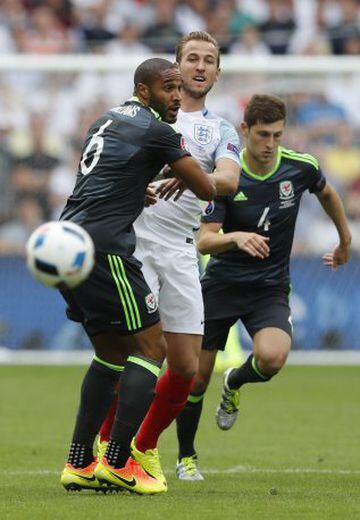 Harry Kane (centre) tussles with Wales captain Ashley Williams (left).