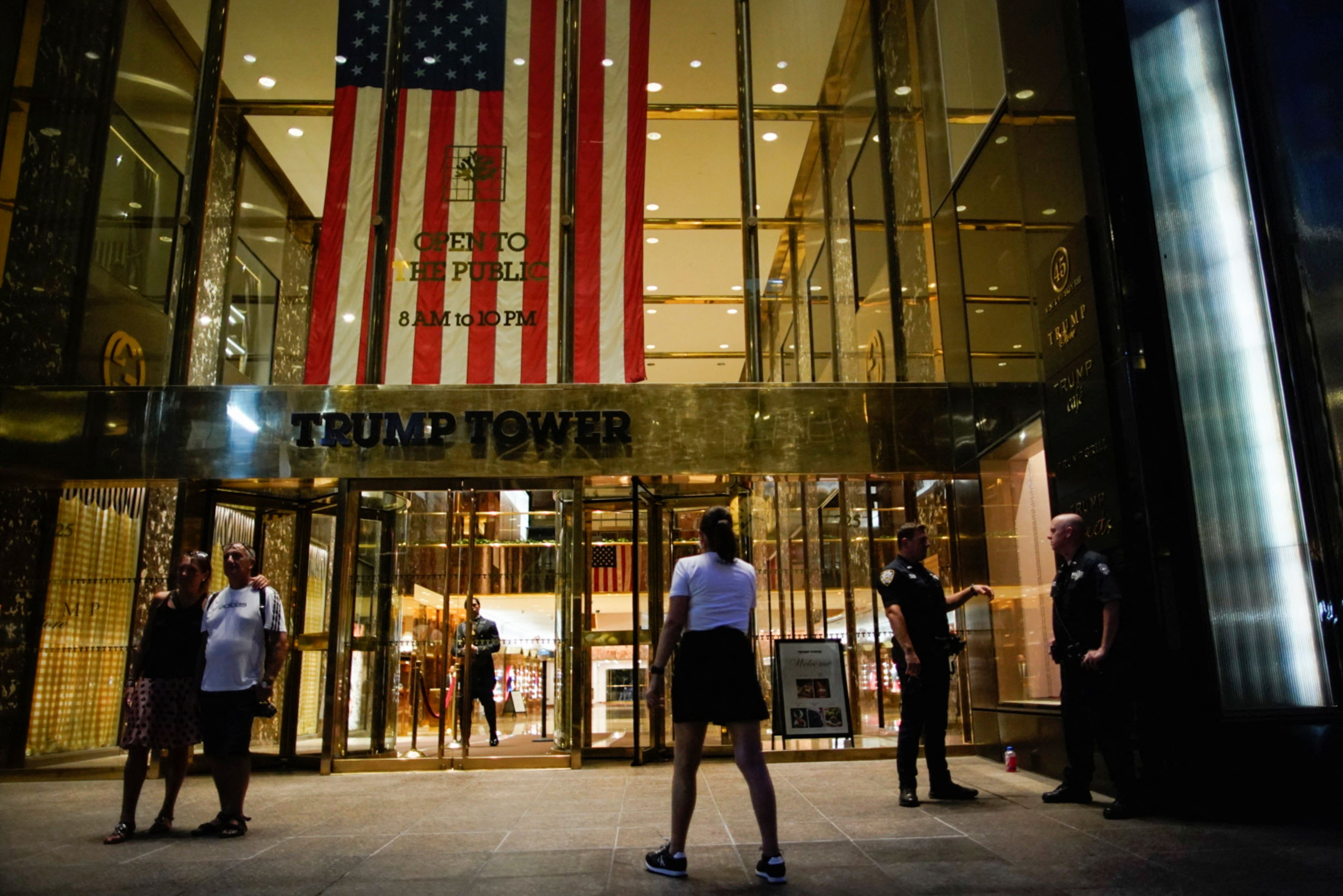 People and police officers stand outside Trump Tower after former U.S. President Donald Trump said that FBI agents raided his Mar-a-Lago Palm Beach home, in New York City, U.S., August 8, 2022. REUTERS/Eduardo Munoz