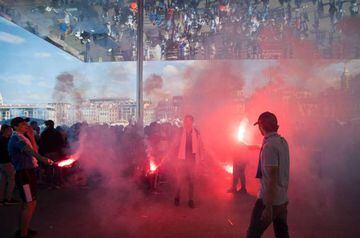 Olympique Marseille supporters let off a flare as they cheer for their team in the Vieux Port in Marseille on May 16, 2018, ahead of the 2018 UEFA Europa Cup Final.